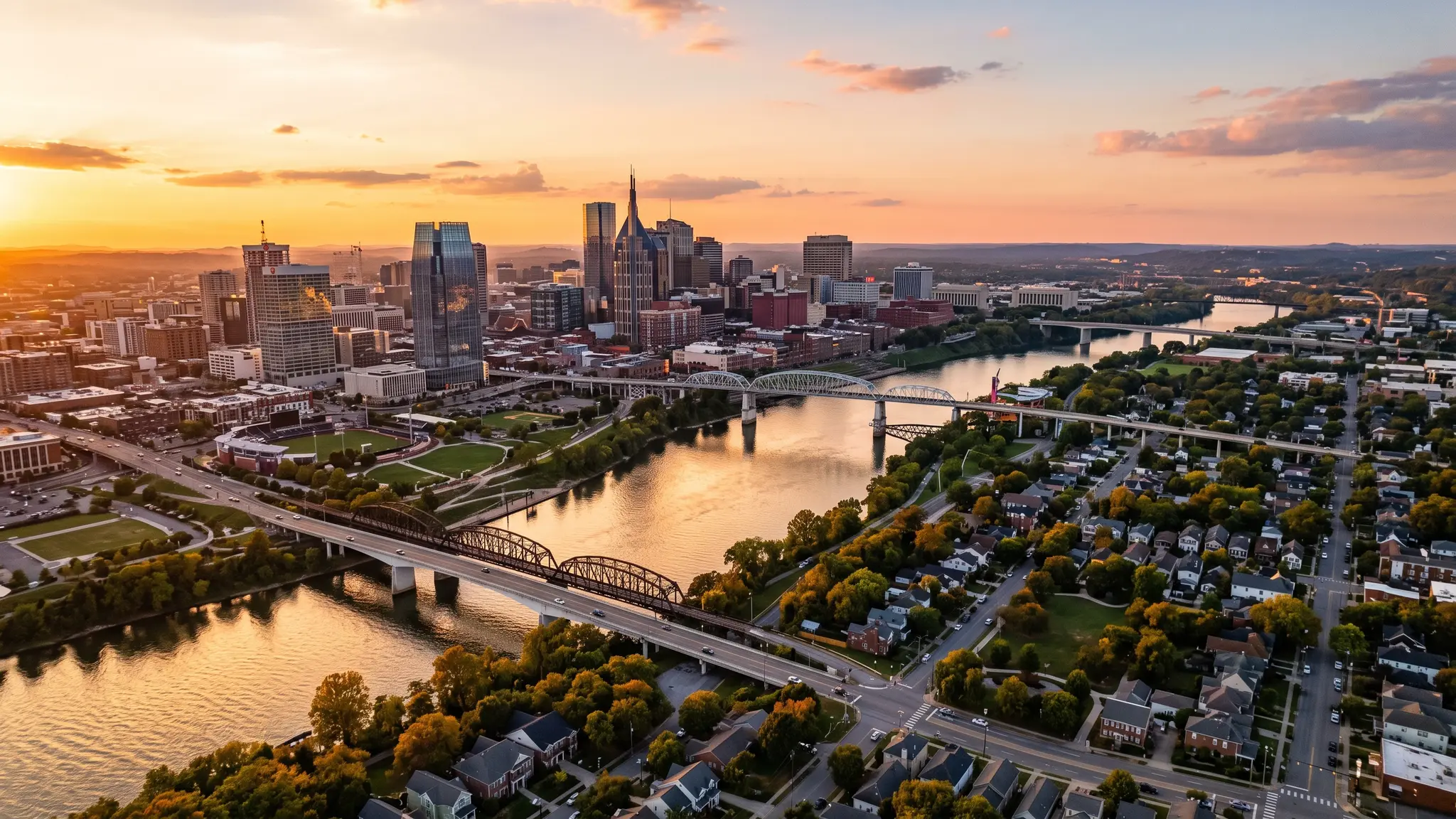 Underground utility service areas in Middle Tennessee | Music City Utilities Aerial view of the Cumberland River winding past the Nashville skyline and Middle Tennessee farmland at sunset
